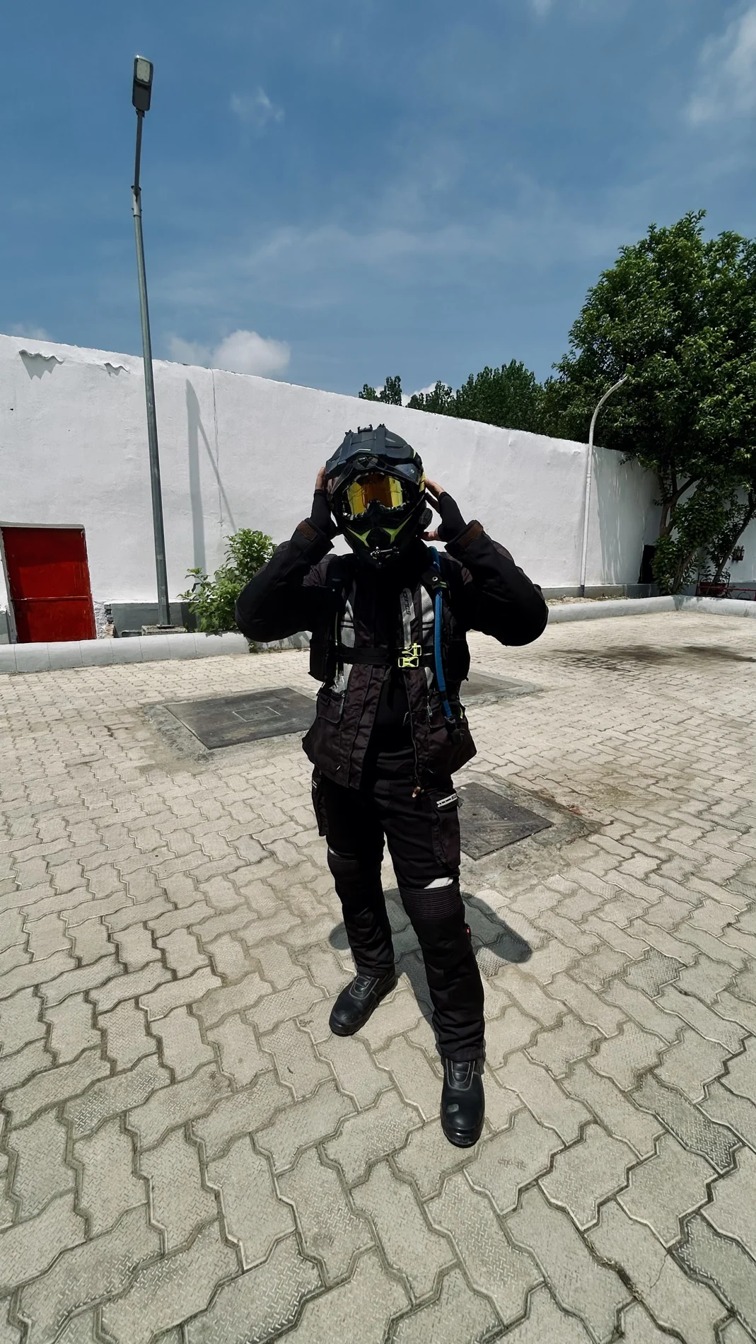 Shubham adjusting his helmet before a motorcycle ride